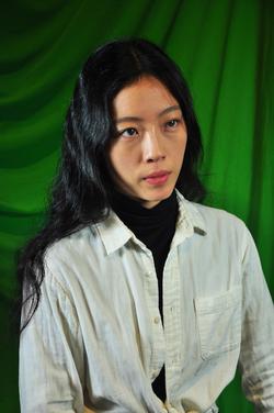 Photo of Mindy Seu in front of a green background. Photo of Mindy Seu in front of a green background.