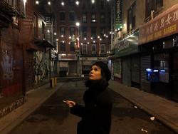 Picture of Alisha Mascarenhas on the street at night.