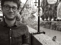 A black and white photo of Isaac Pickell beside a canal 