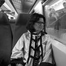 Black and white photo of Carla Harryman looking out a window