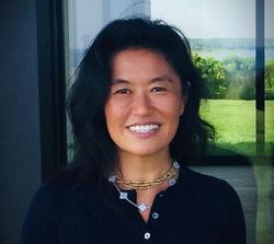 This is a headshot of Rail Board Member, Helen Lee with a window background overlooking a garden.