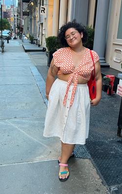 A photo of Devyn Lorelei Mañibo standing on the sidewalk 