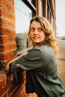 A photo of Sommer Browning against a brick wall