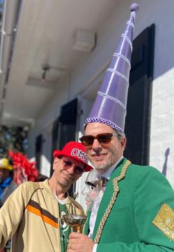 A photo of Brett with a tall purple cone hat