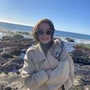 A photo of Maia Siegel in a coat and sunglasses