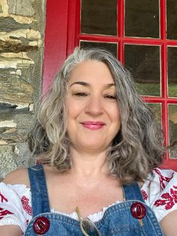 A photo of Nada Gordon in front of a red window 