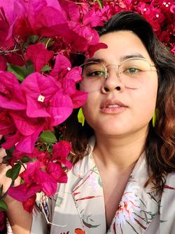 A photo of Tina Lentz-McMillan among hot pink flowers 