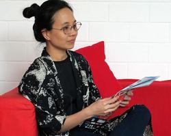 Photo of Nguyen Trinh Thi in a red chair