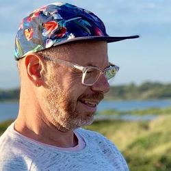 An image of Paul Soulellis, standing outside in a blue hat.