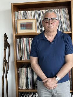 A photo of Ted Pearson in front of records 