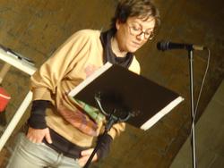 Photo of Noura Wedell reading.