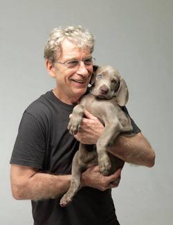 Photo of William Wegman with his dog